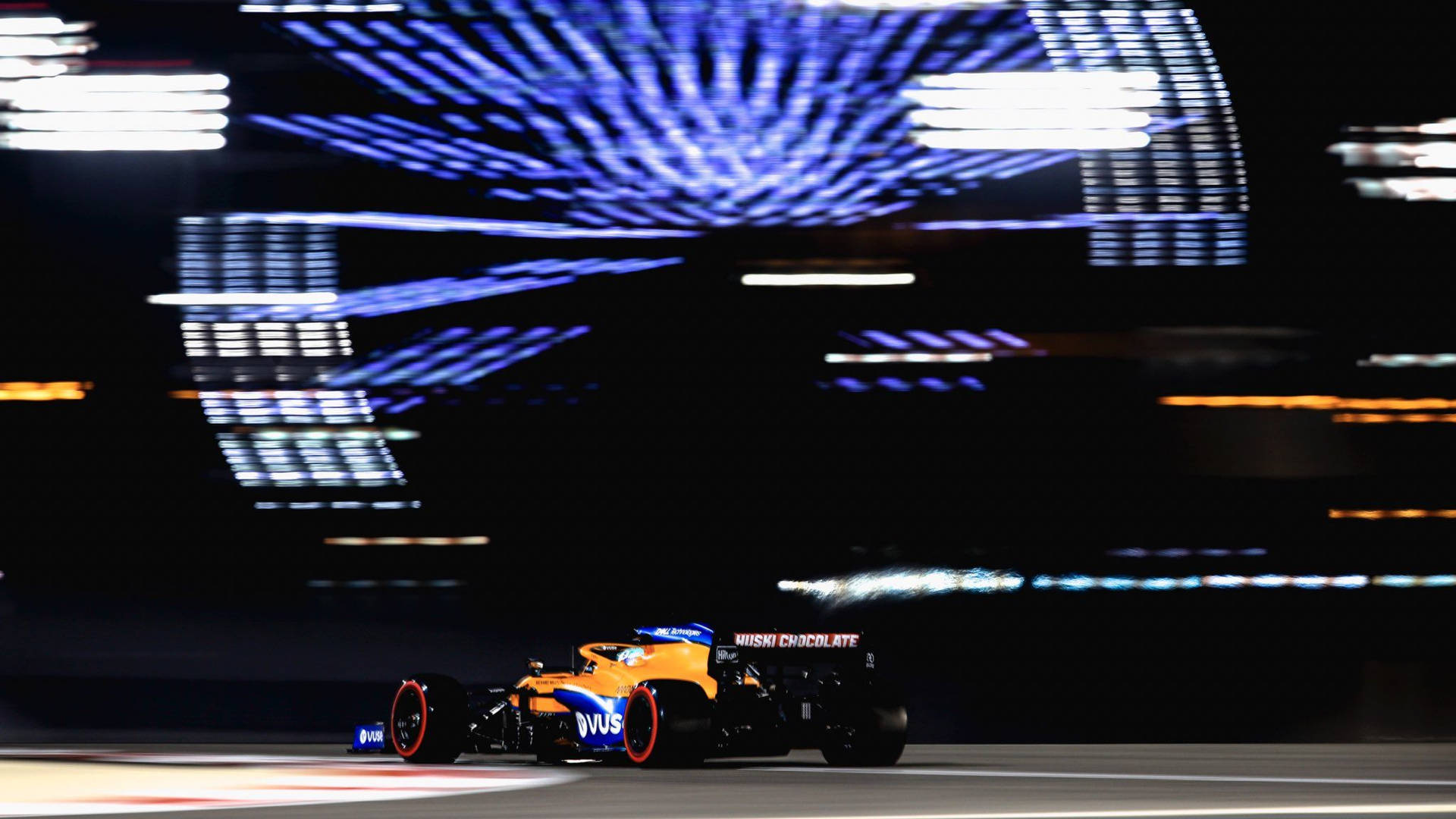 Daniel Ricciardo F1 Car Against Billboard Screen Background