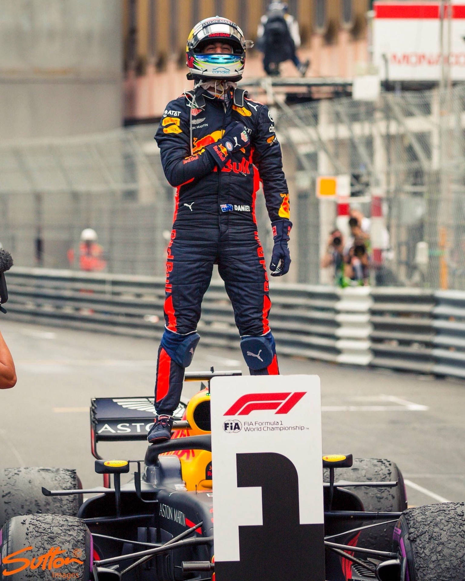 Daniel Ricciardo Standing On Formula One Car Background