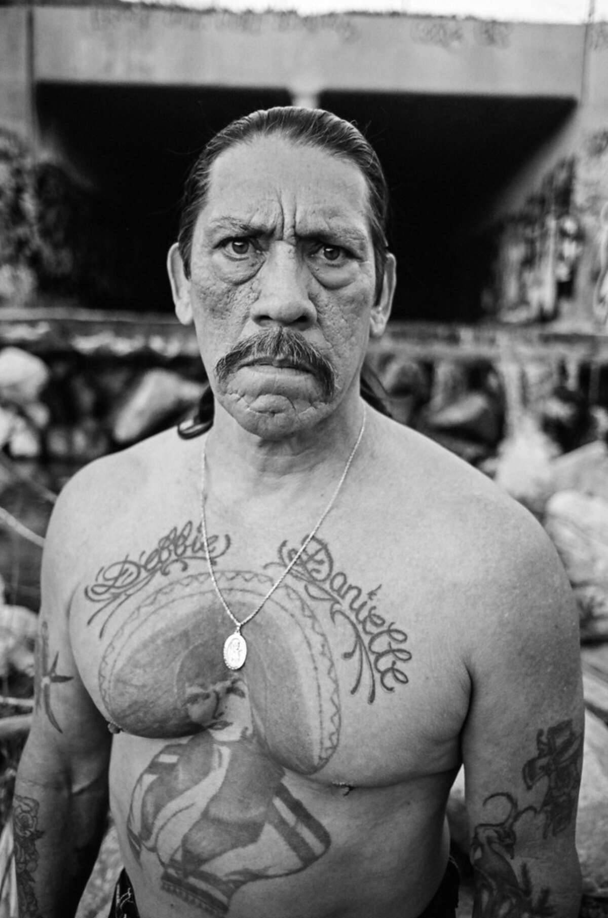 Danny Trejo Exposing His Body Tattoos Background