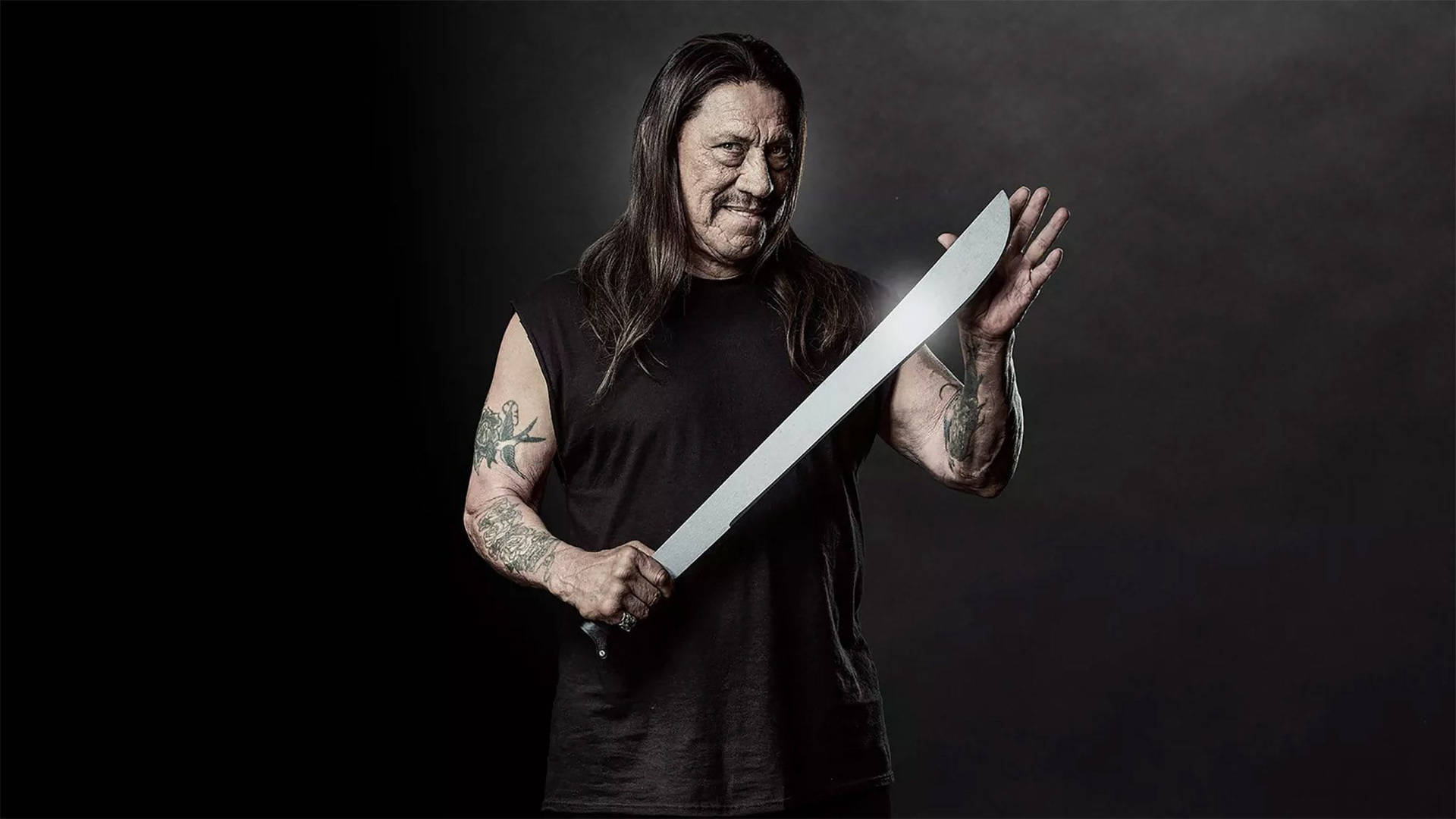 Danny Trejo With Silver Machete Background