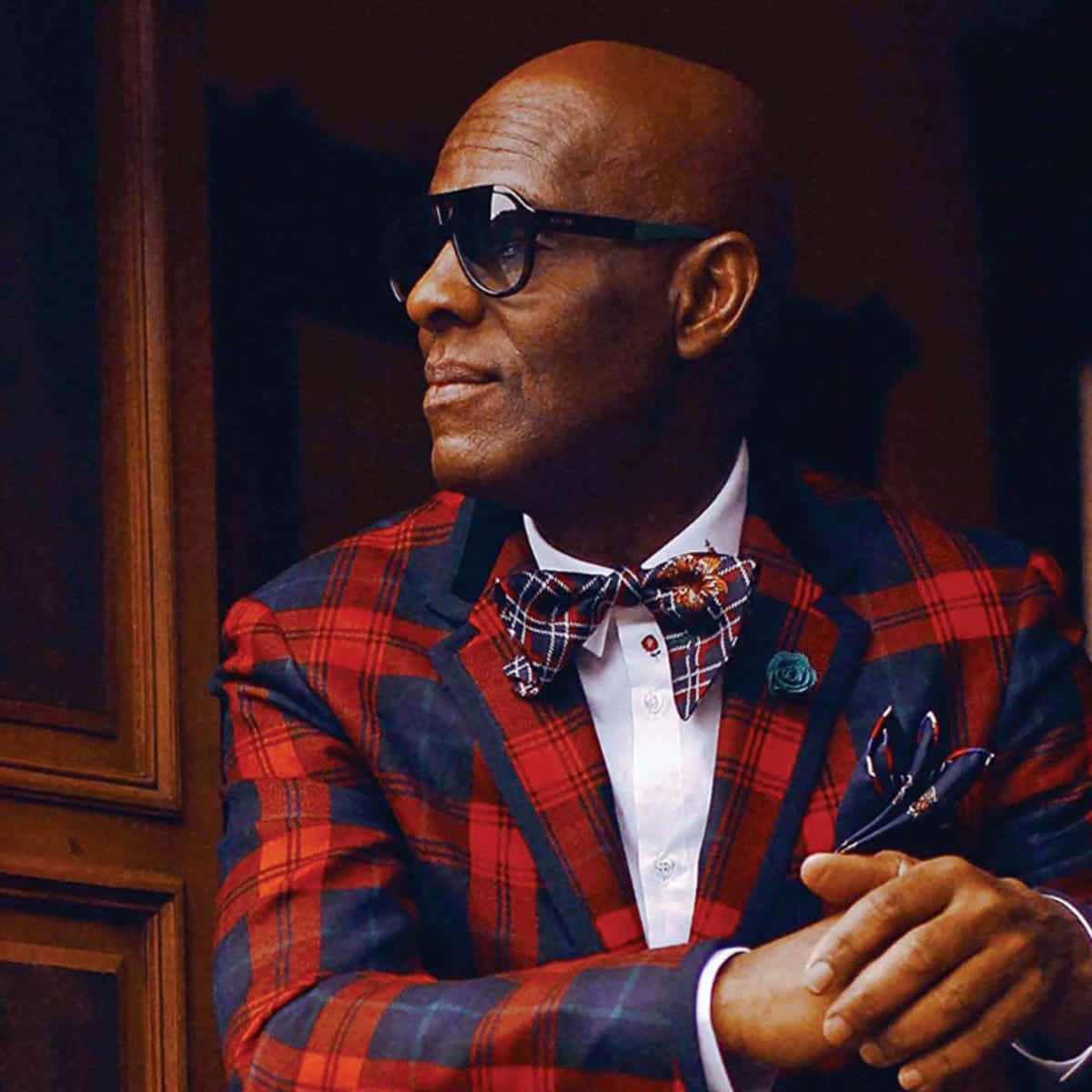 Dapper Dan Looking Sharp In Plaid Suit Background