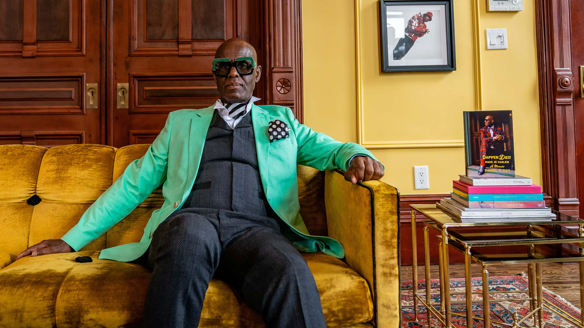 Dapper Dan Relaxing On A Couch Background