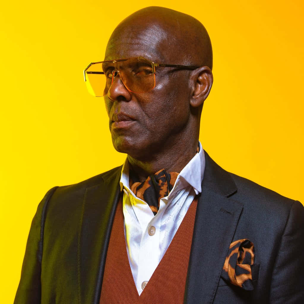 Dapper Dan Wearing Animal Printed Scarf Background