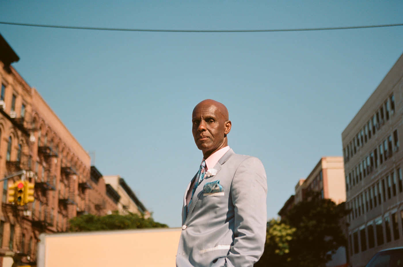 Dapper Dan Wearing Silver Formal Attire Background