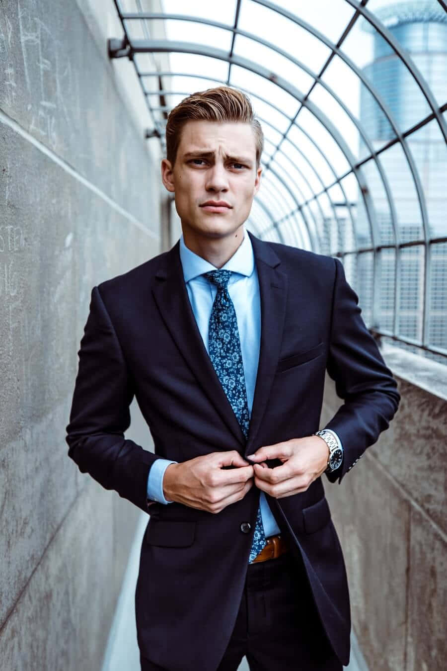 Dapper Man Fixing A Button Background