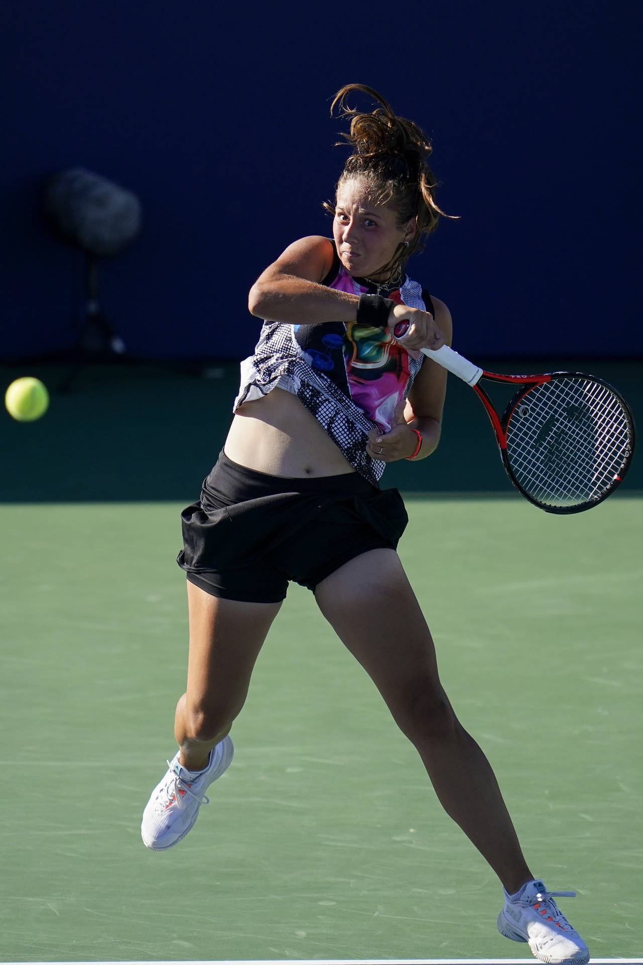 Daria Kasatkina Delivers A Powerful Swing During A Tennis Match Background