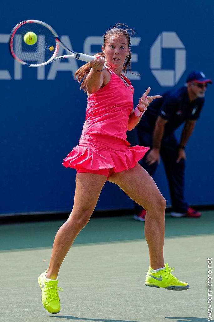 Daria Kasatkina Strikes Ball In Pink Background