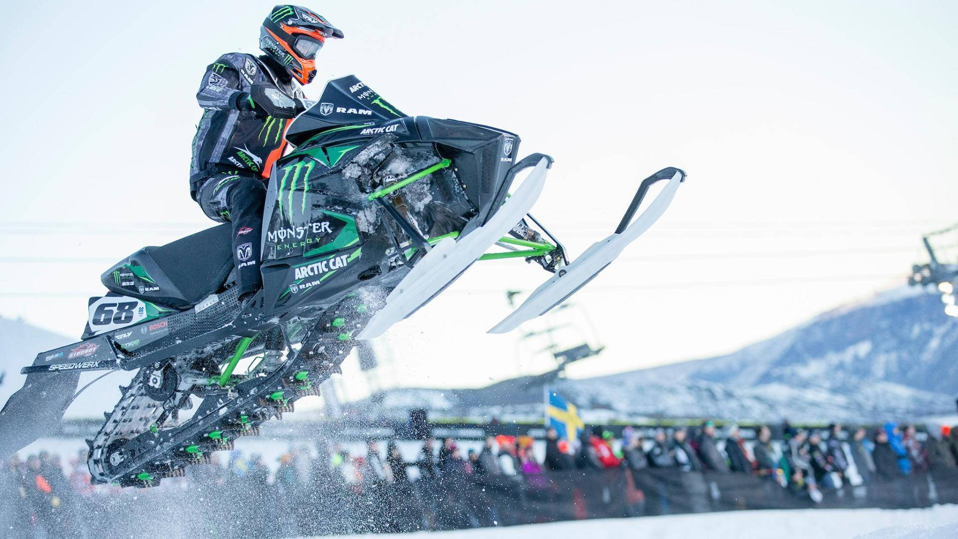 Daring Snowmobile Stunt At X Games Background