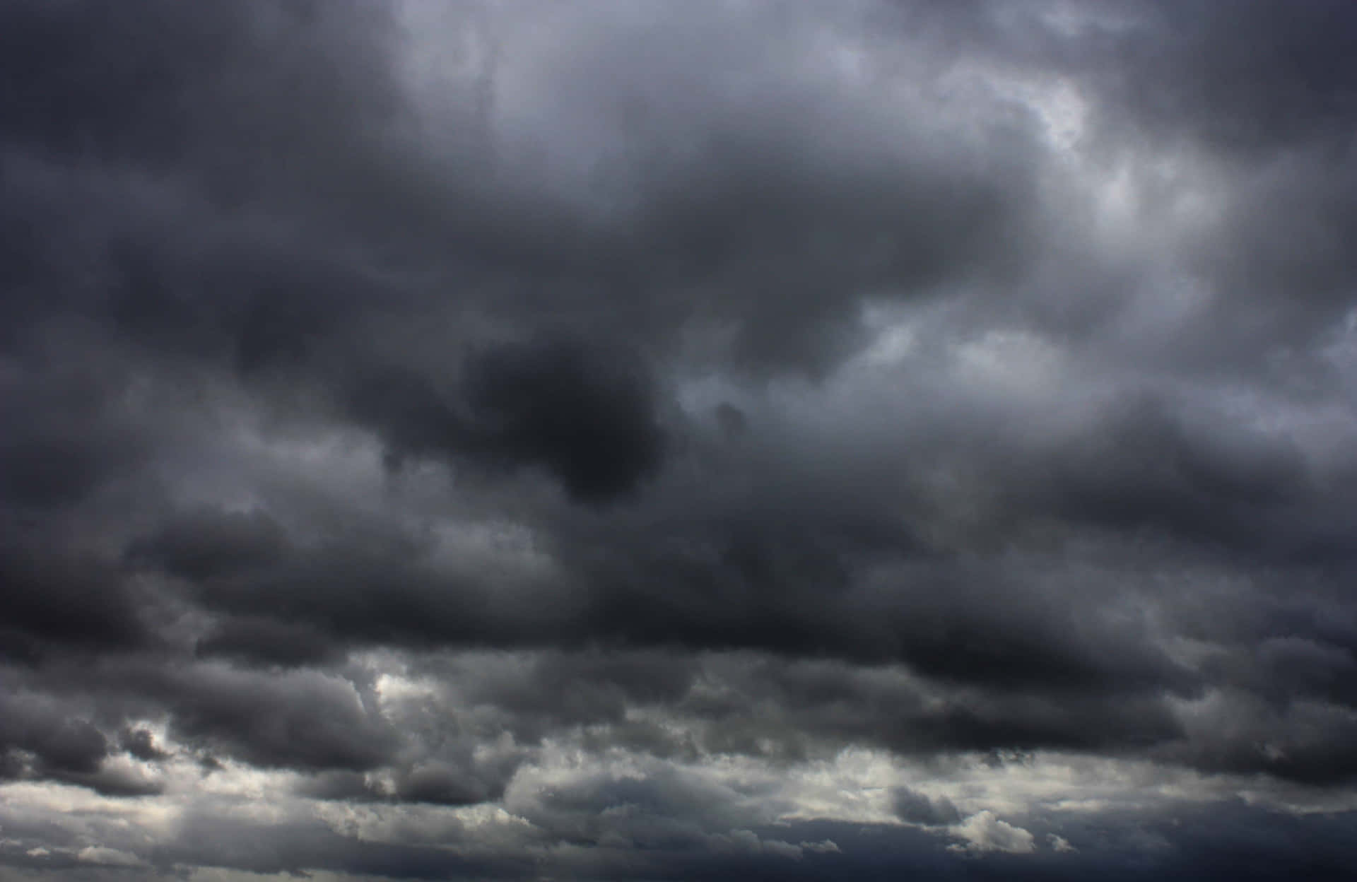 Dark And Light - A Contrasting View Of A Puffy Cloud Background