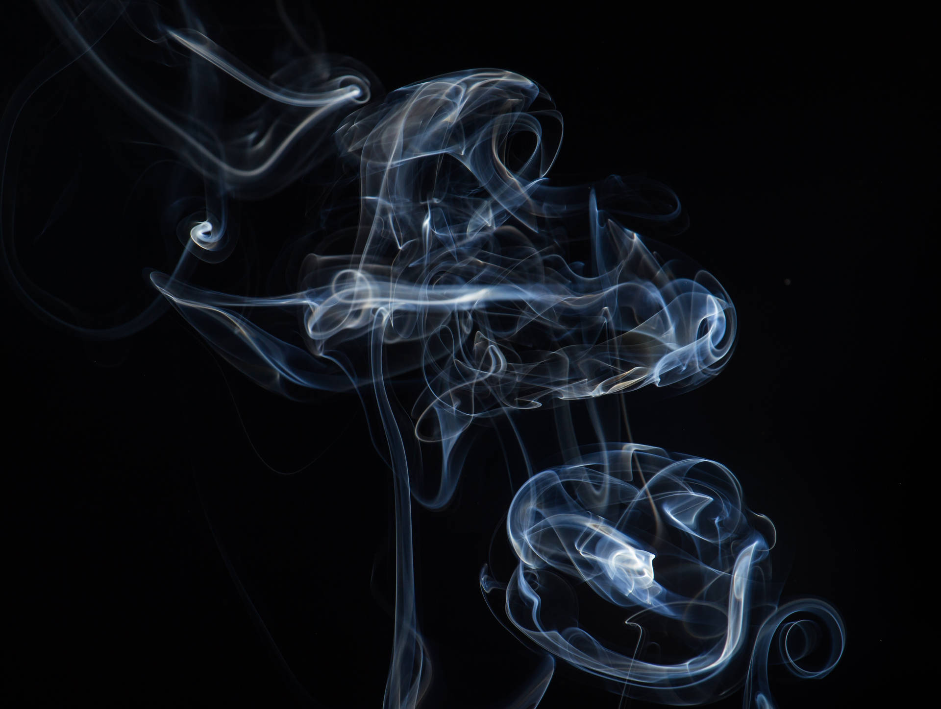 Dark And Mysterious Smoke Swirling Through The Sky Background