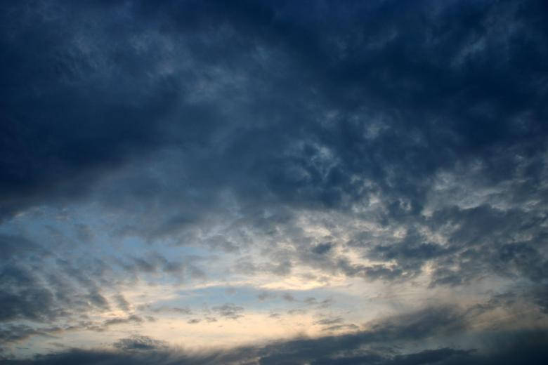 Dark Blue Clouds At Mid-day Background