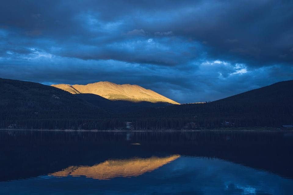 Dark Blue Clouds Over Lake Background