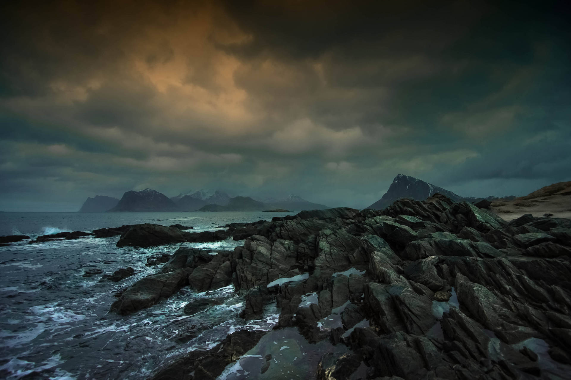 Dark Blue Clouds Over Rocky Seas Background
