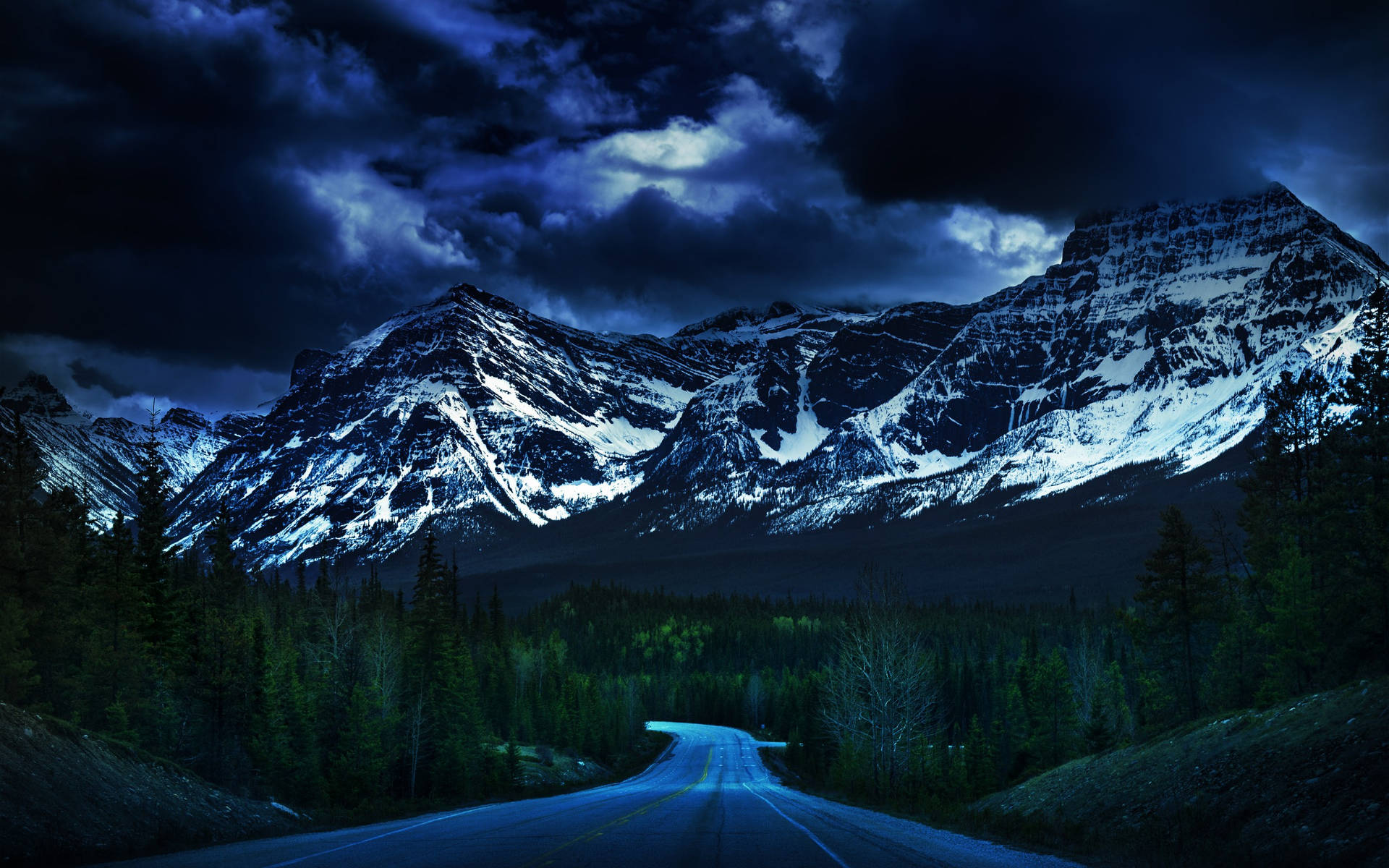 Dark Blue Clouds Over Snowy Mountains Background