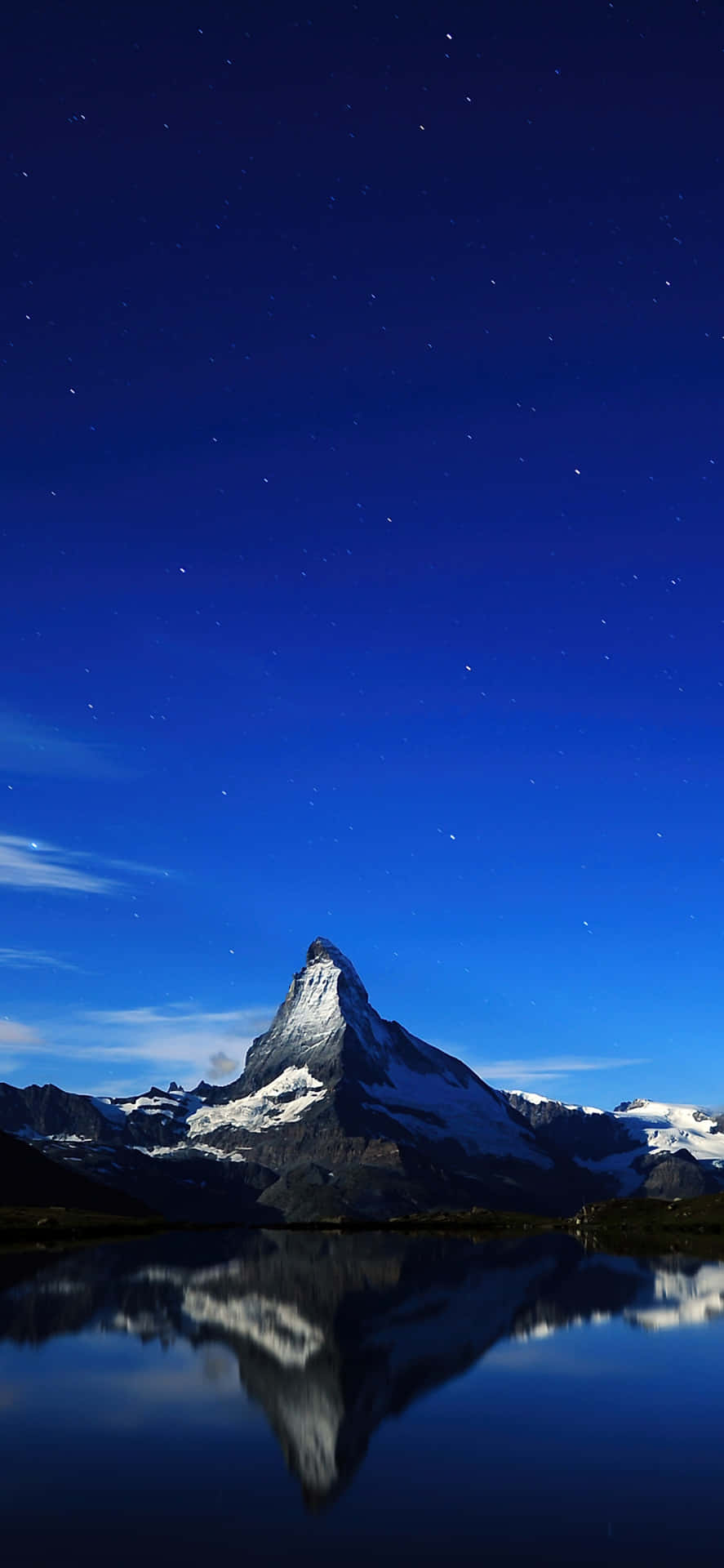 Dark Blue Starry Sky Above Matterhorn Background