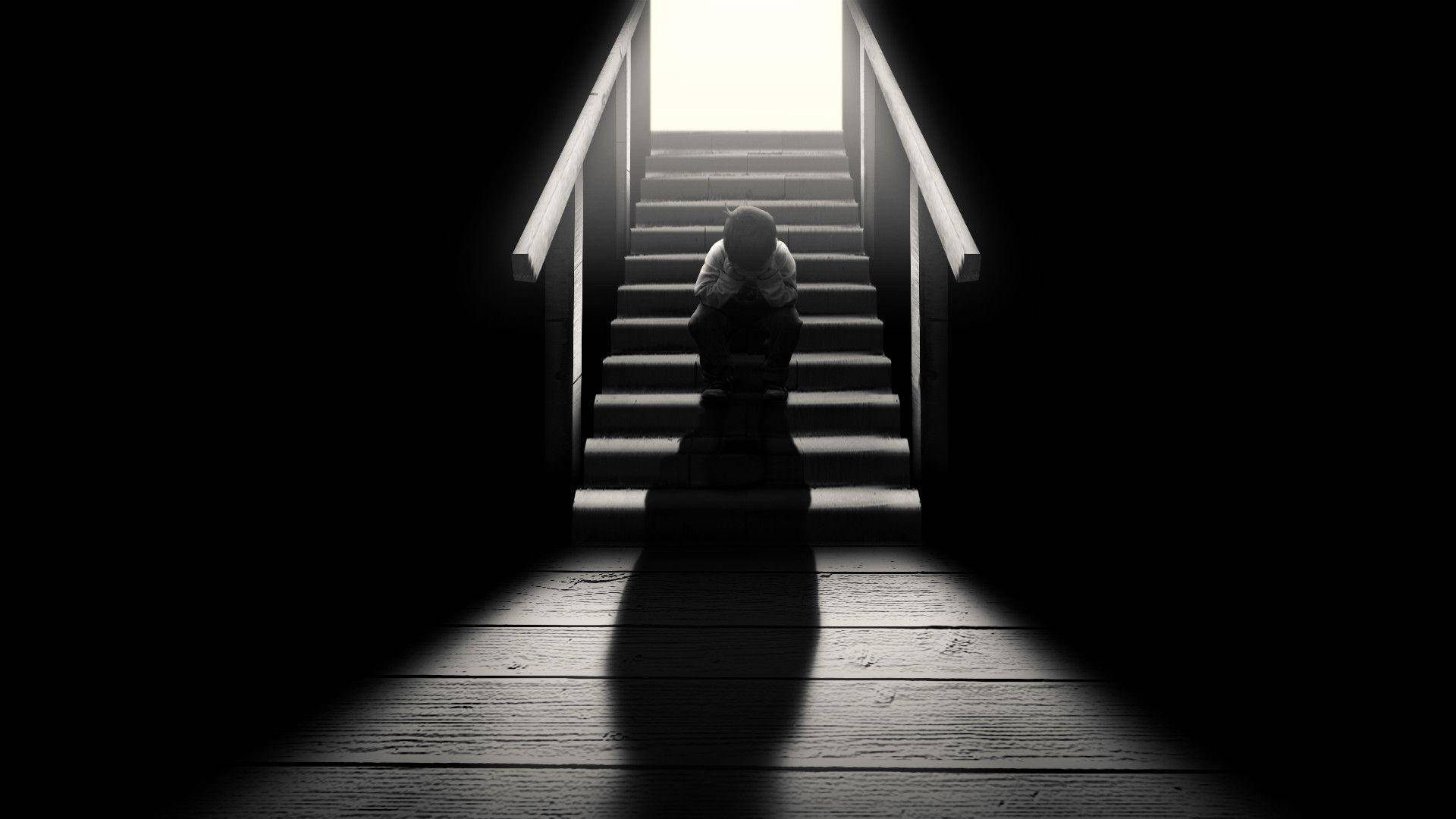 Dark Loneliness: A Solitary Figure On A Staircase Background