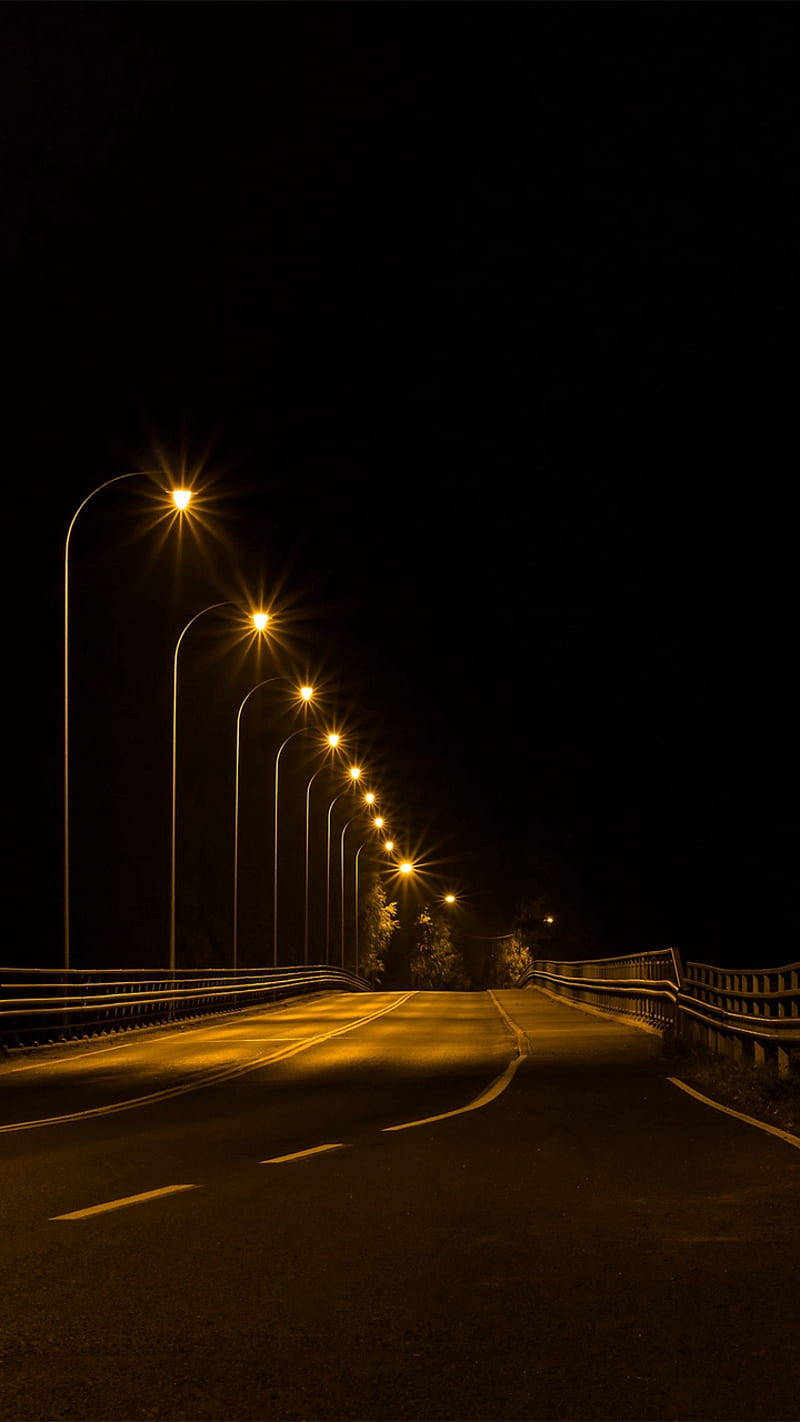 Dark Night Road With Street Lights Background