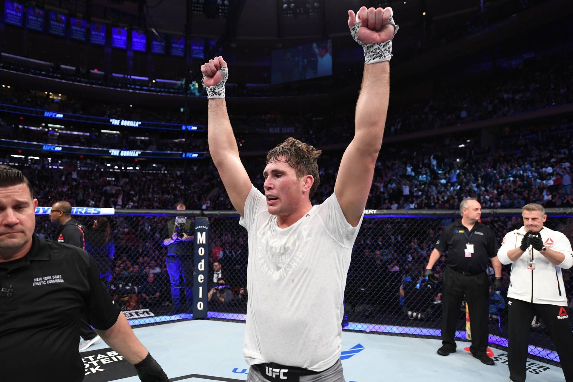 Darren Till Raising Arms In Victory Background