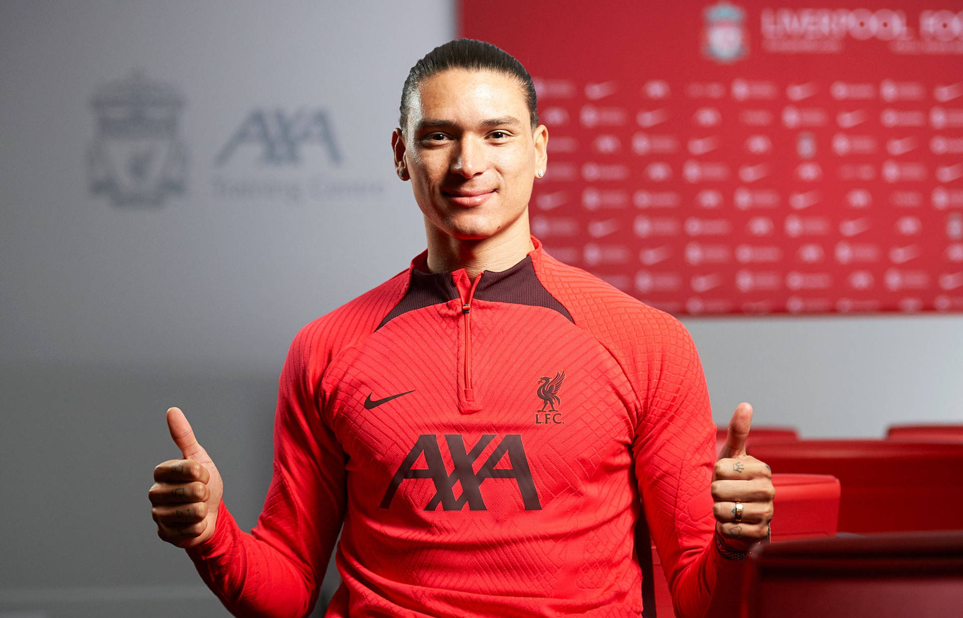 Darwin Núñez Celebrating Victory With A Double Thumbs-up Gesture. Background