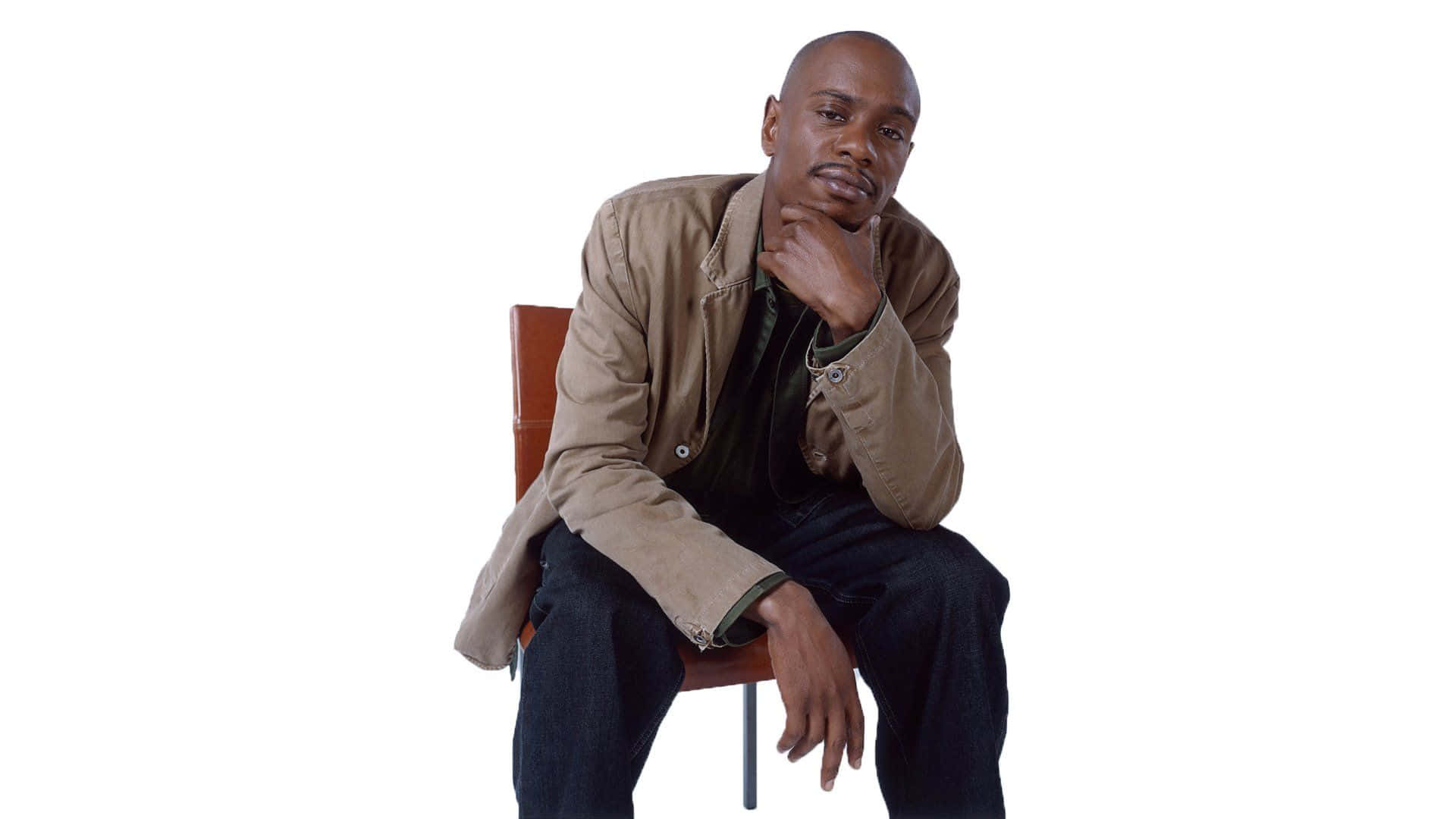 Dave Chappelle Onstage Delivering An Impactful Comedy Performance Background
