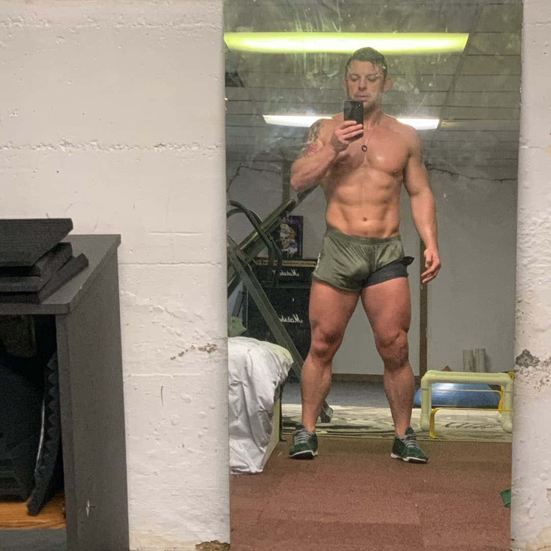 Davey Richards Showing Off Physique In Intense Workout Session Background