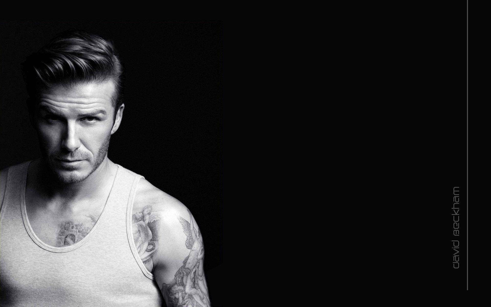 David Beckham Shows Off His Muscular Physique In A Black Tank Top Background