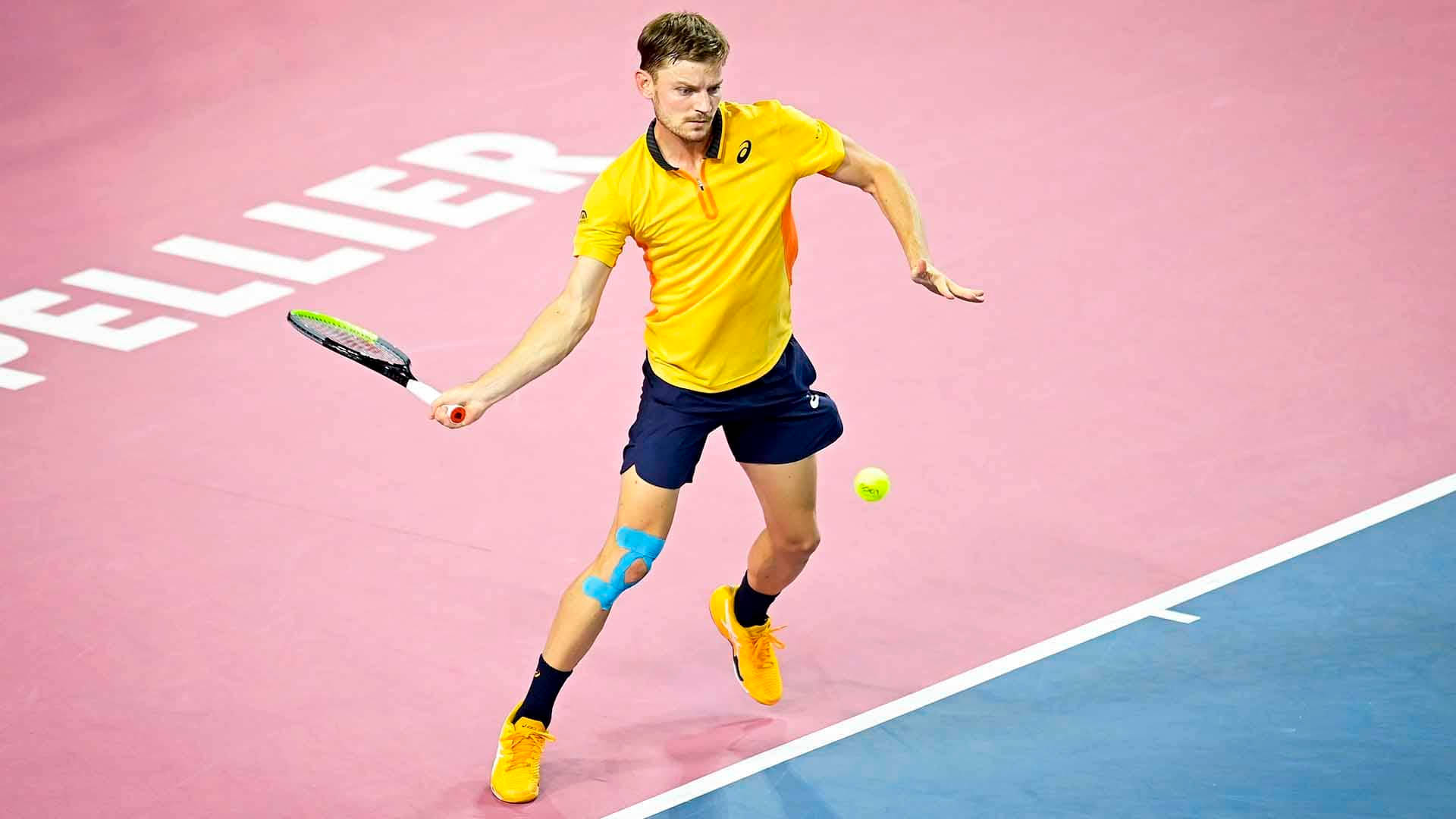 David Goffin In Action On Tennis Court Background