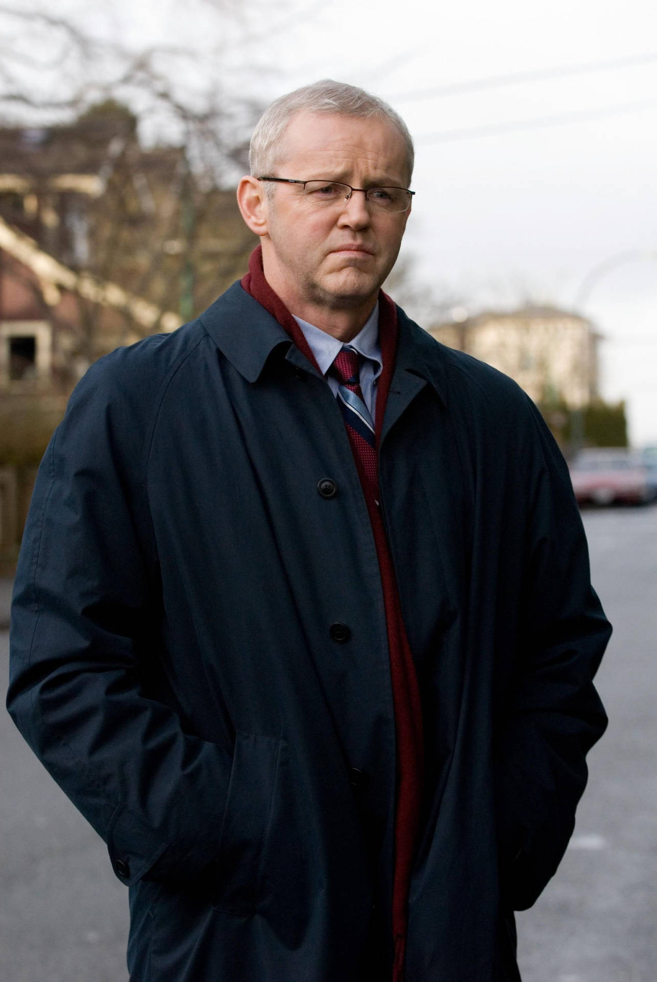 David Morse In Big Black Coat And Specs Background