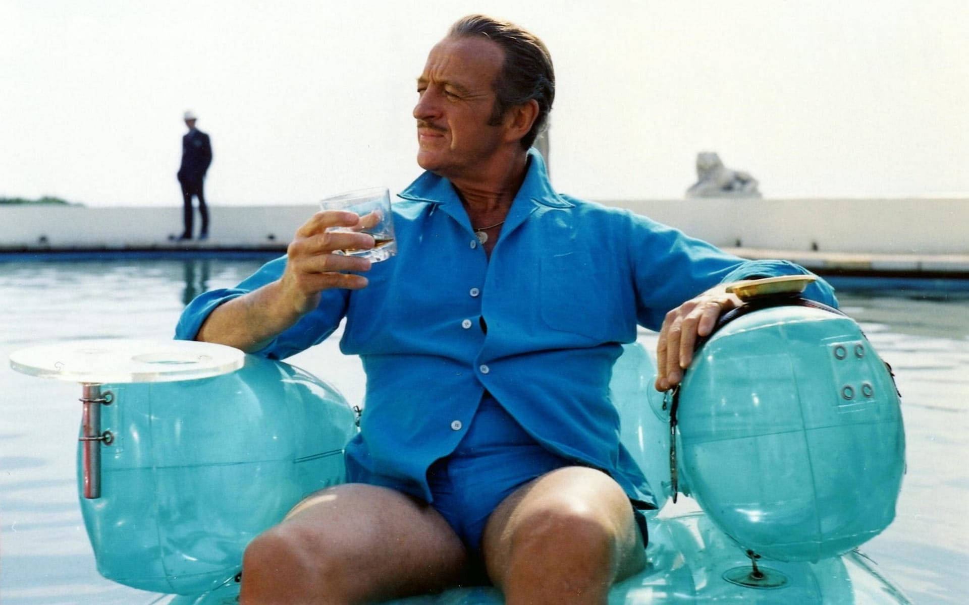 David Niven Holding Glass And Sitting Background