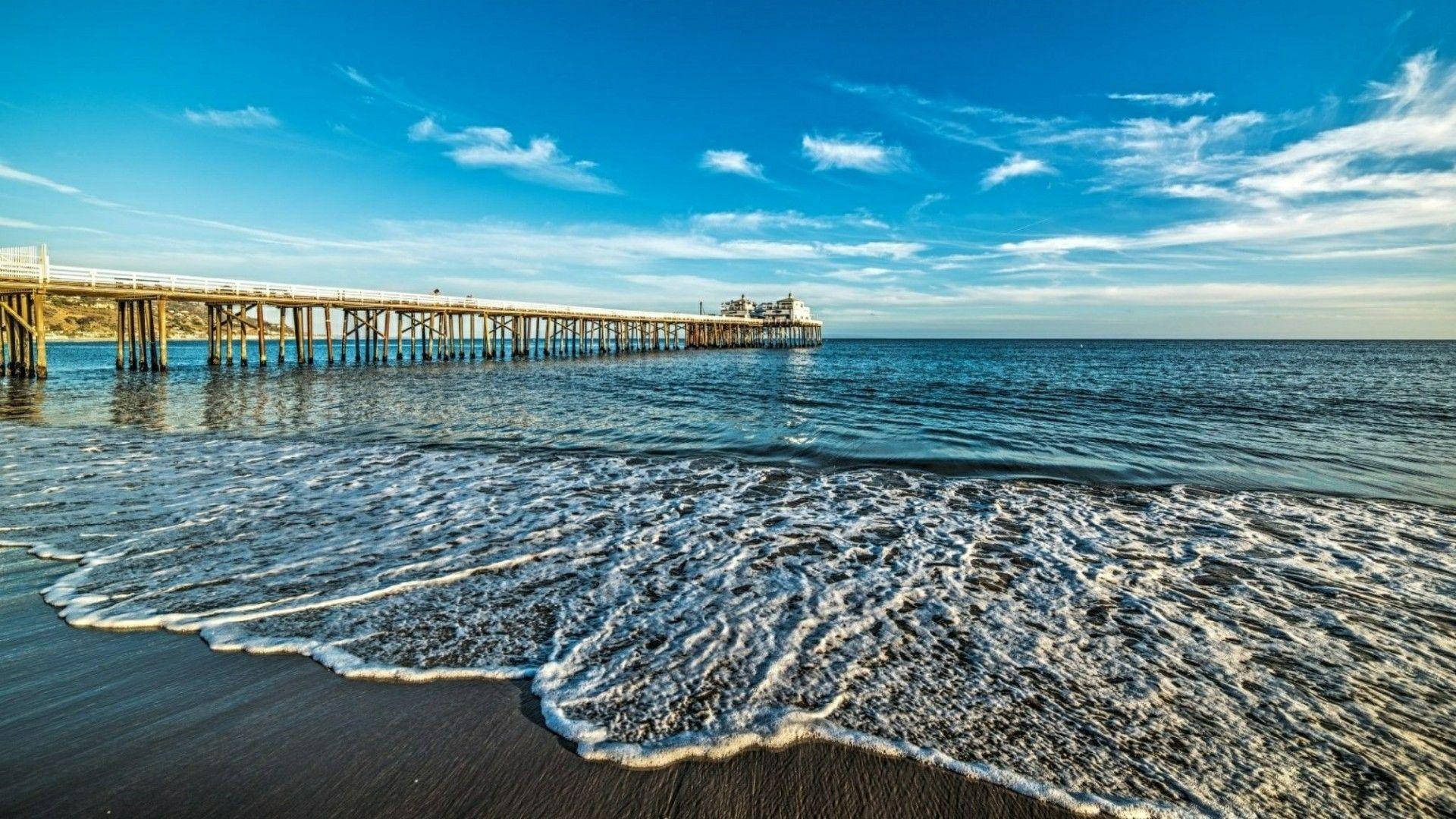 Daylight Splendor At Malibu Beach Pier Background