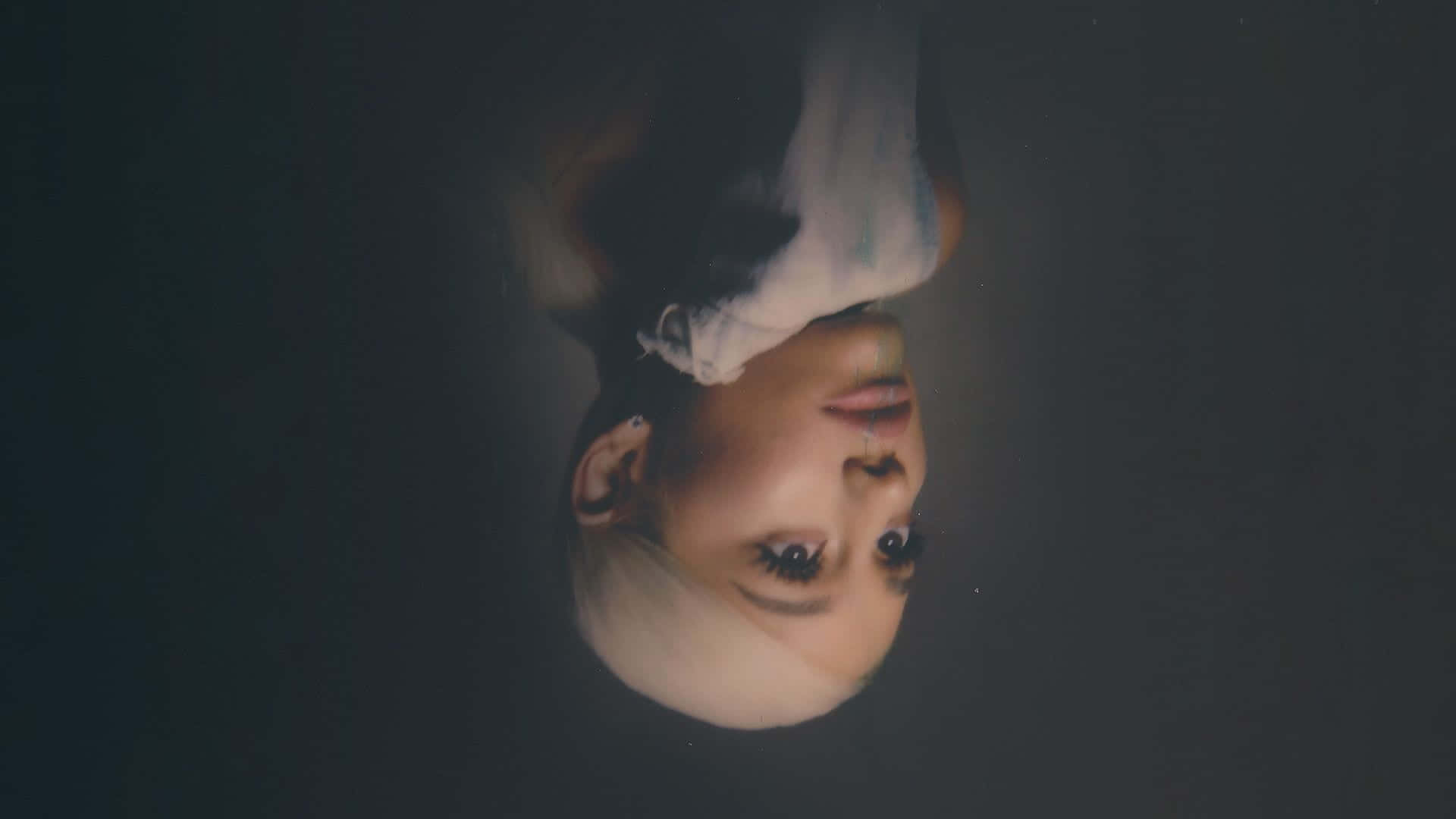 Dazzling Ariana Grande In A Vibrant Setting Background