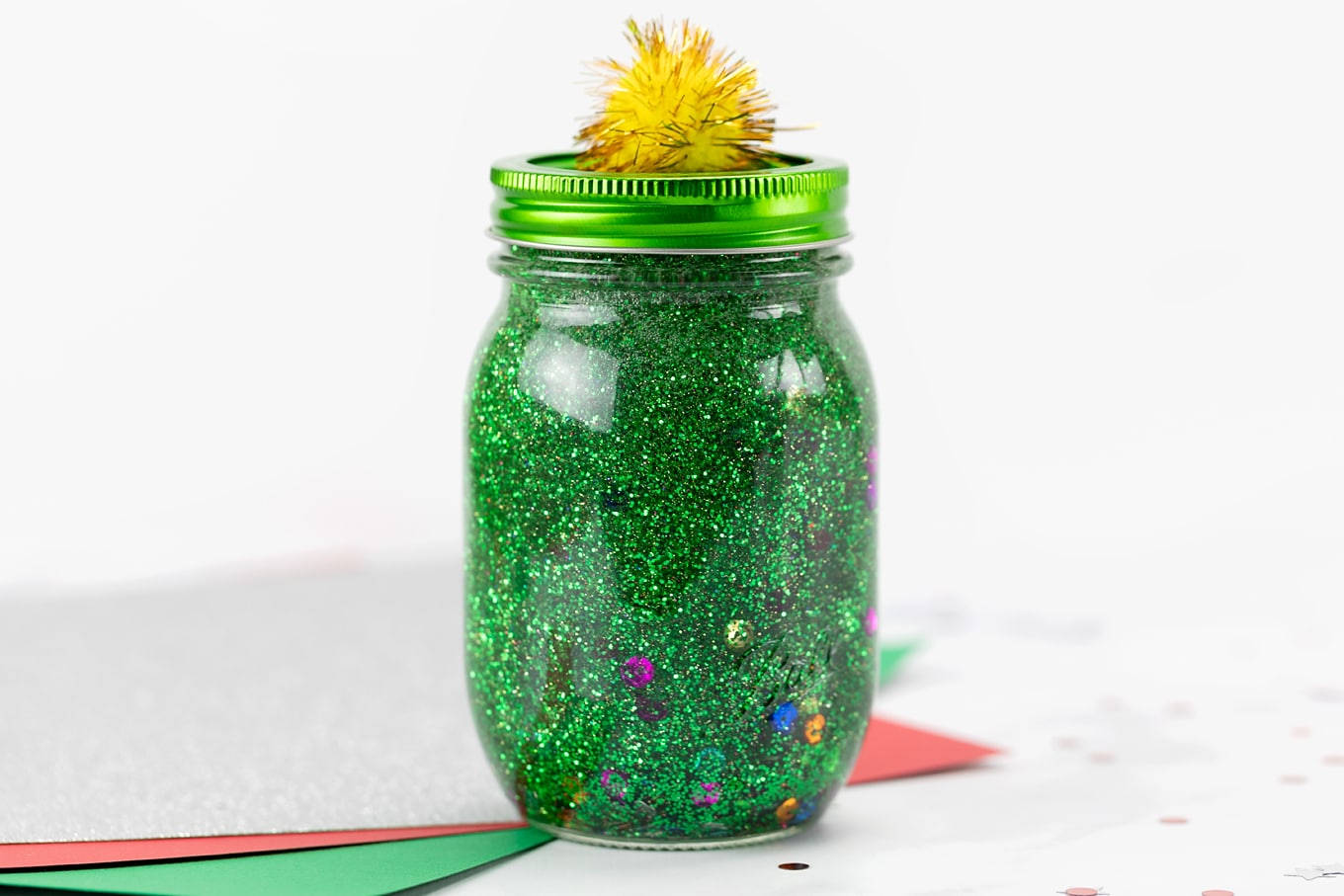 Dazzling Green Glitter In A Glass Jar Background