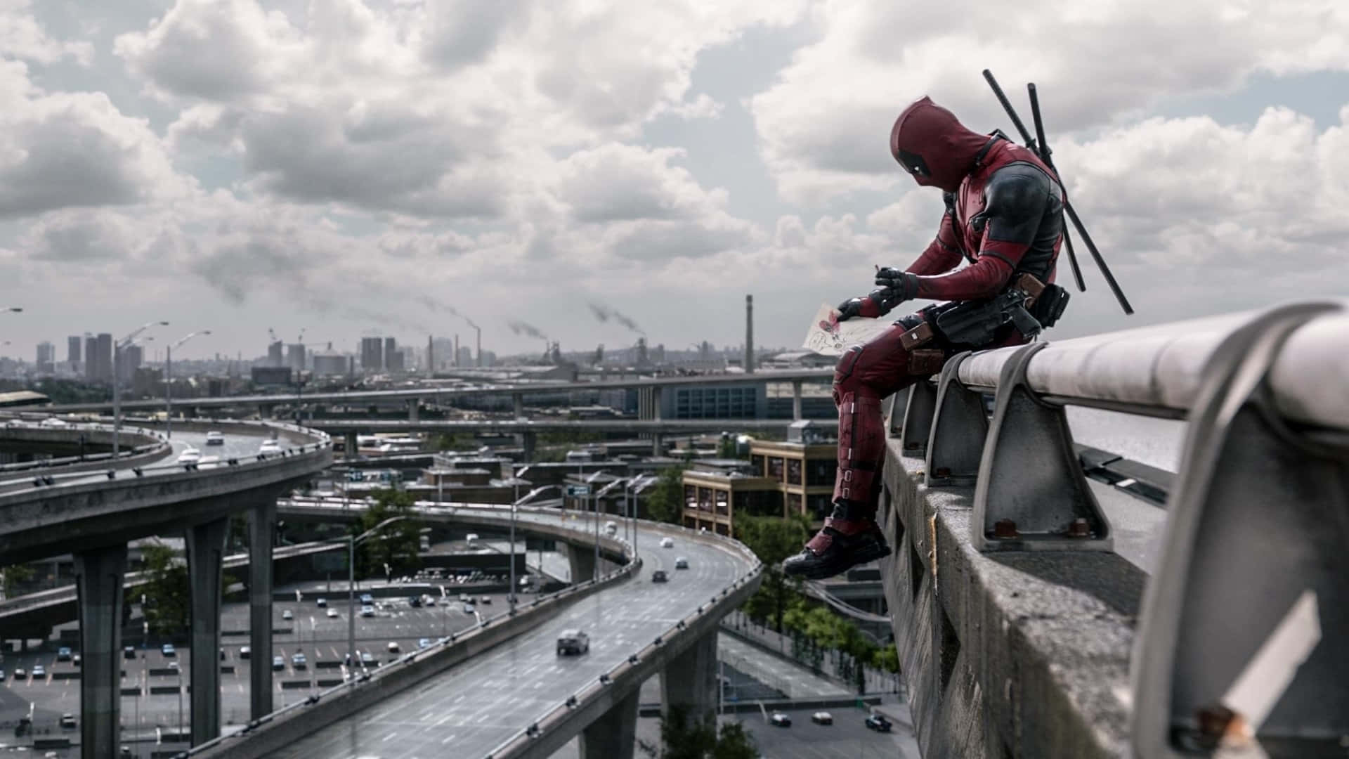 Deadpool - A Man Sitting On A Railing Background