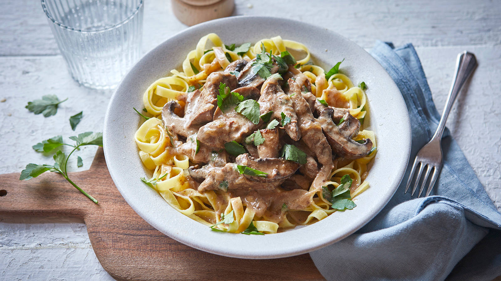 Decadent Beef Stroganoff With Pasta And Fresh Parsley Background