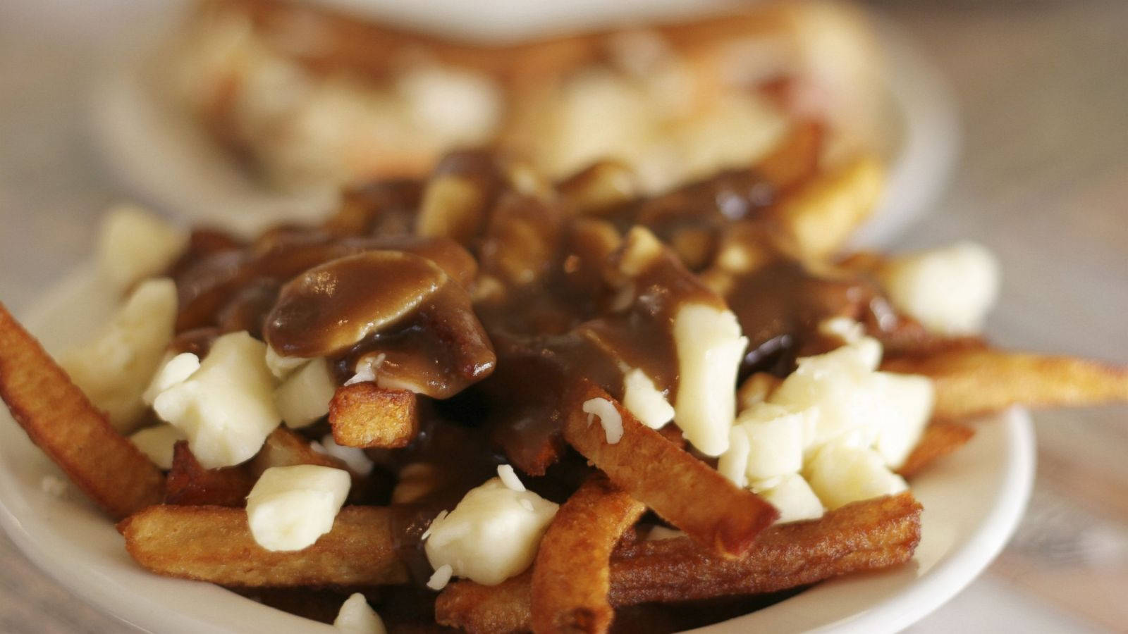 Decadent Poutine With Rich Gravy Background