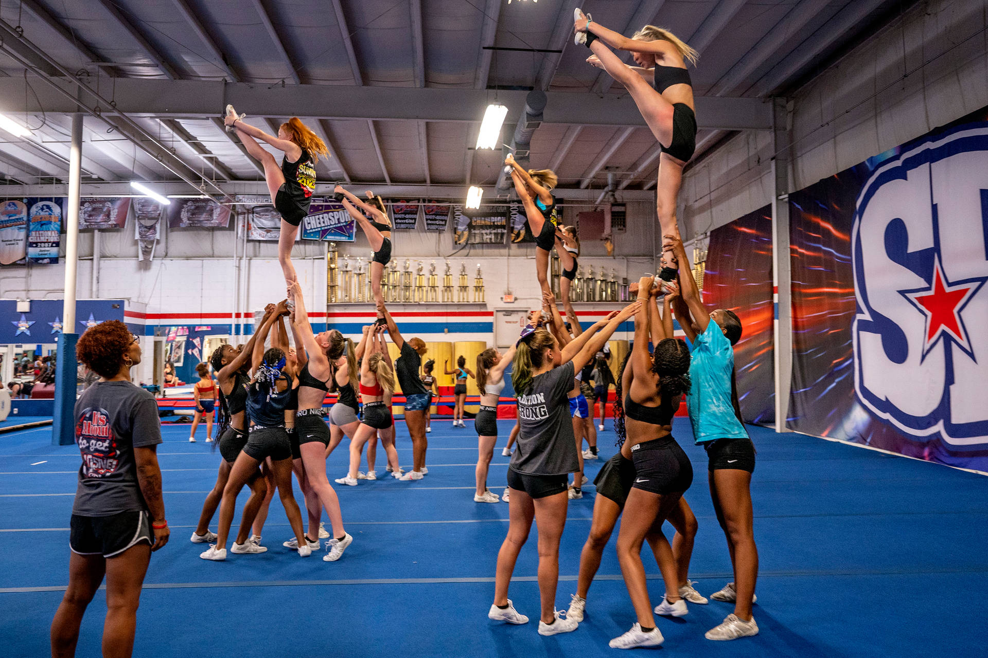 Dedicated Cheerleader Performing A Perfect Heel Stretch