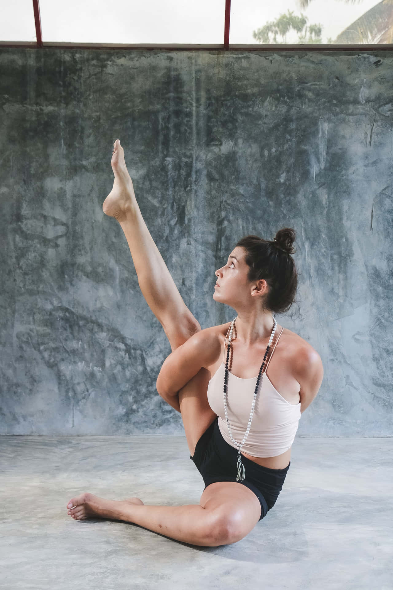 Dedicated Woman Practicing Wide-legged Yoga Pose Background