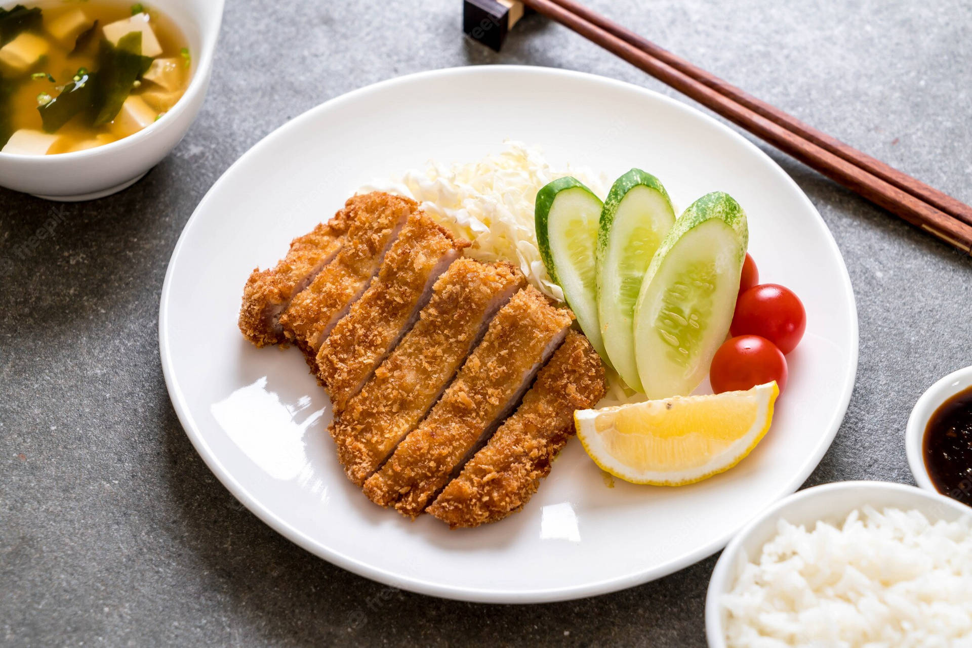 Deep-fried Tonkatsu On A White Plate Background