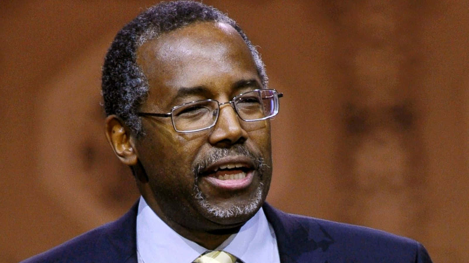 Deep In Thought - A Close-up Portrait Of Ben Carson Background