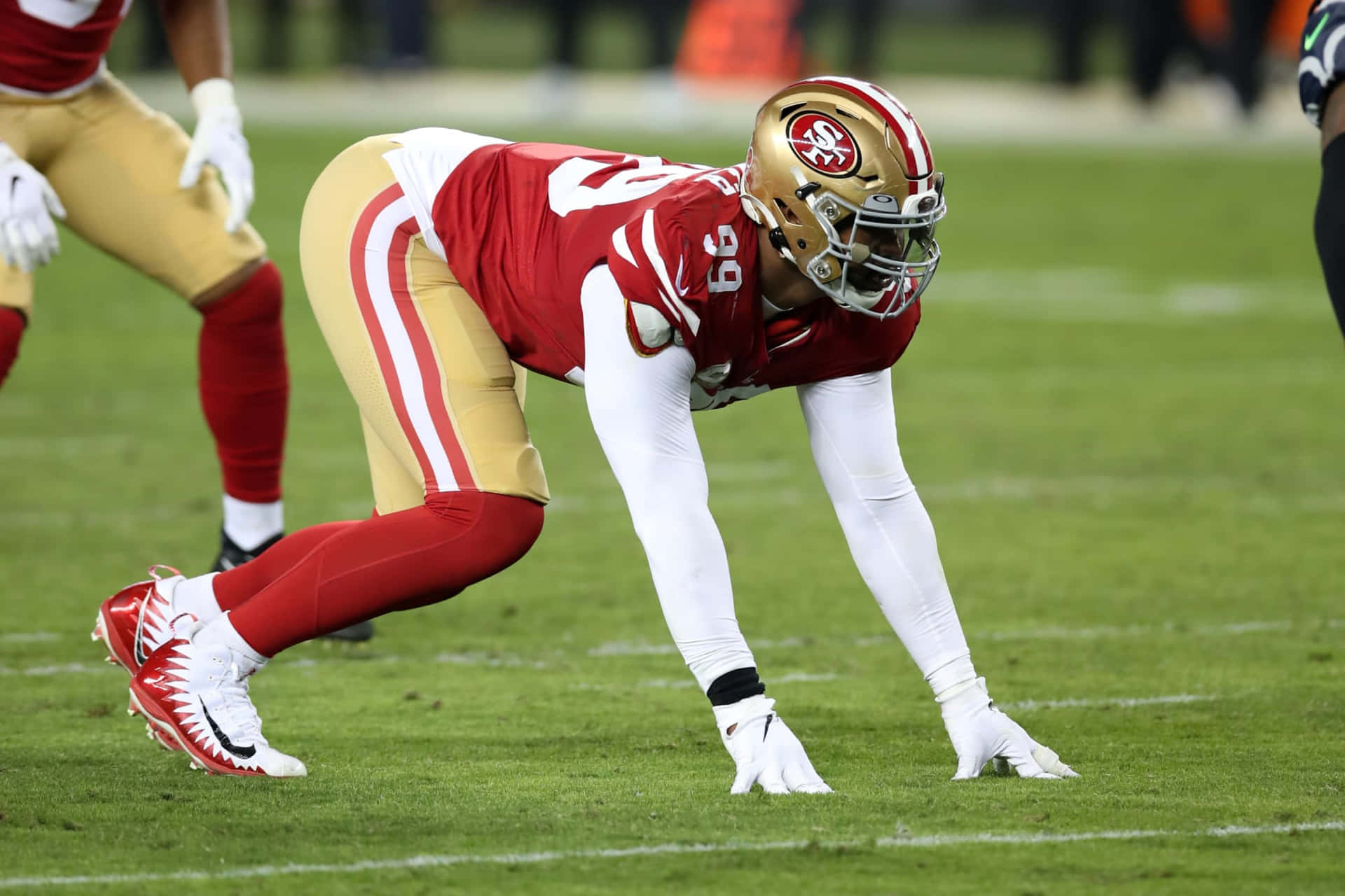 Deforest Buckner Footballer On All Fours Background