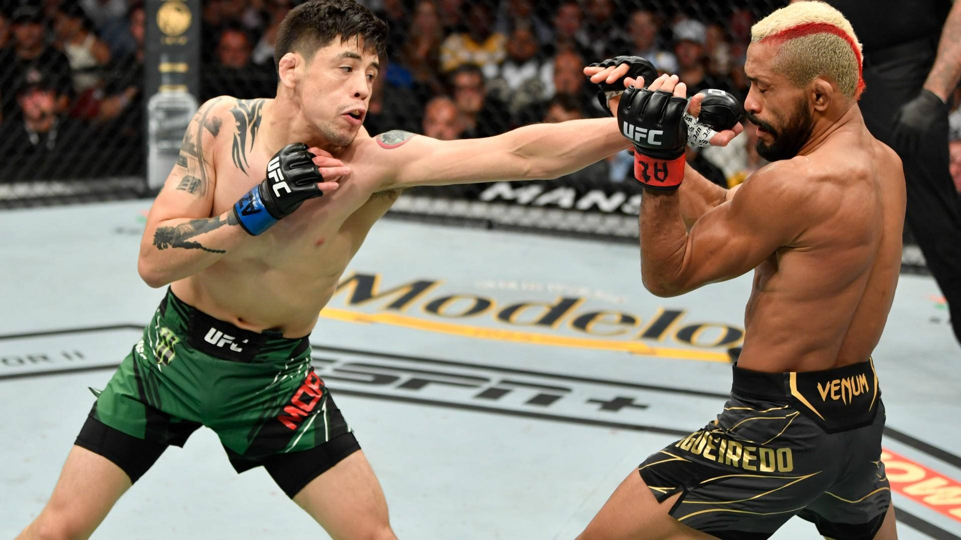 Deiveson Figueiredo Blocking Brandon Moreno’s Punch Background