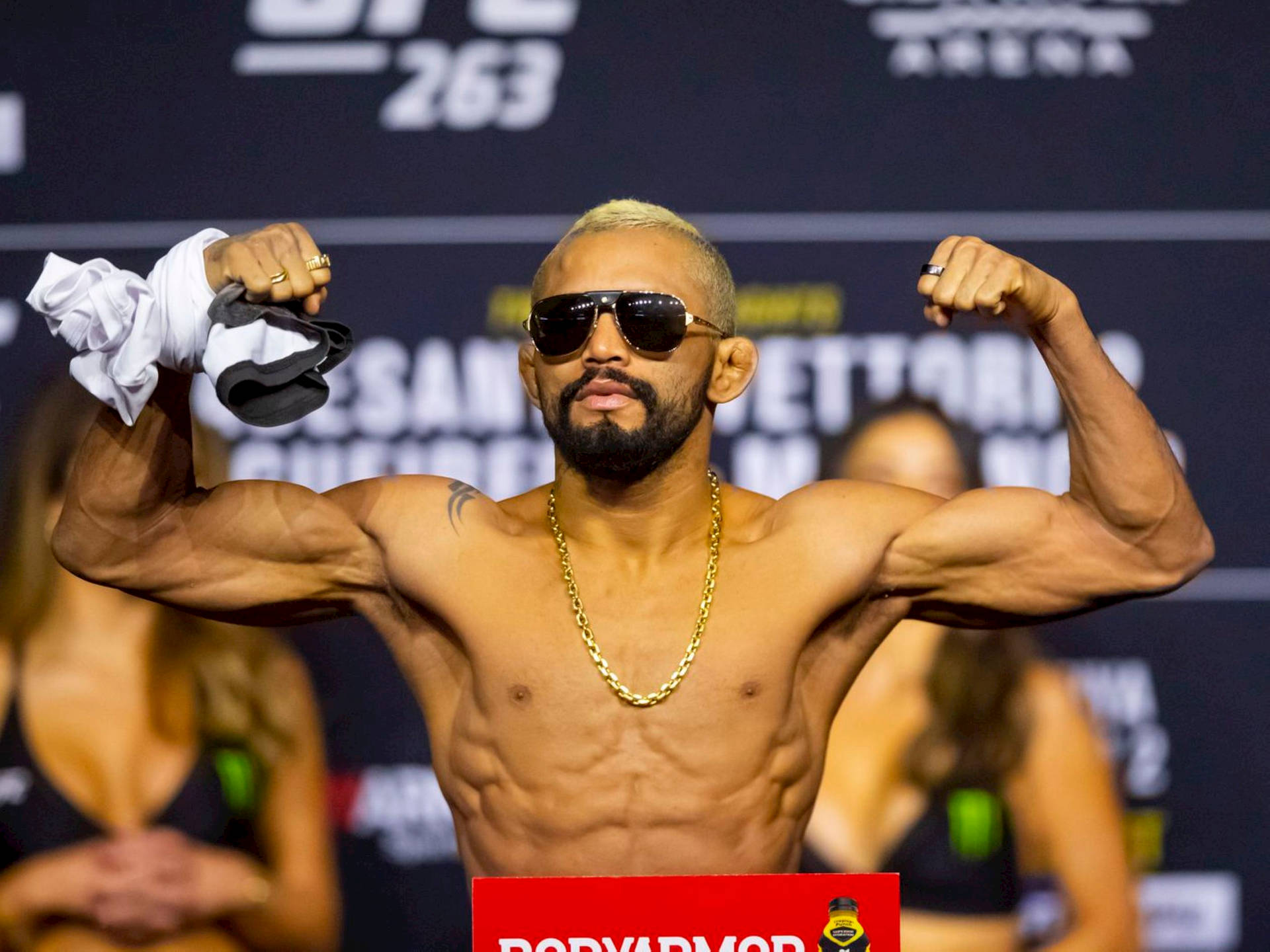 Deiveson Figueiredo Flexing With Sunglasses Background