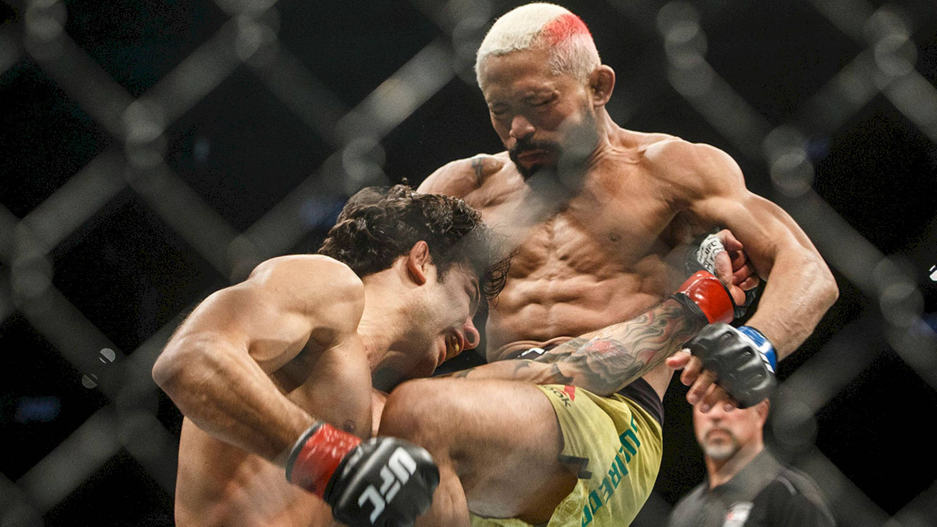 Deiveson Figueiredo In Intense Fight Background