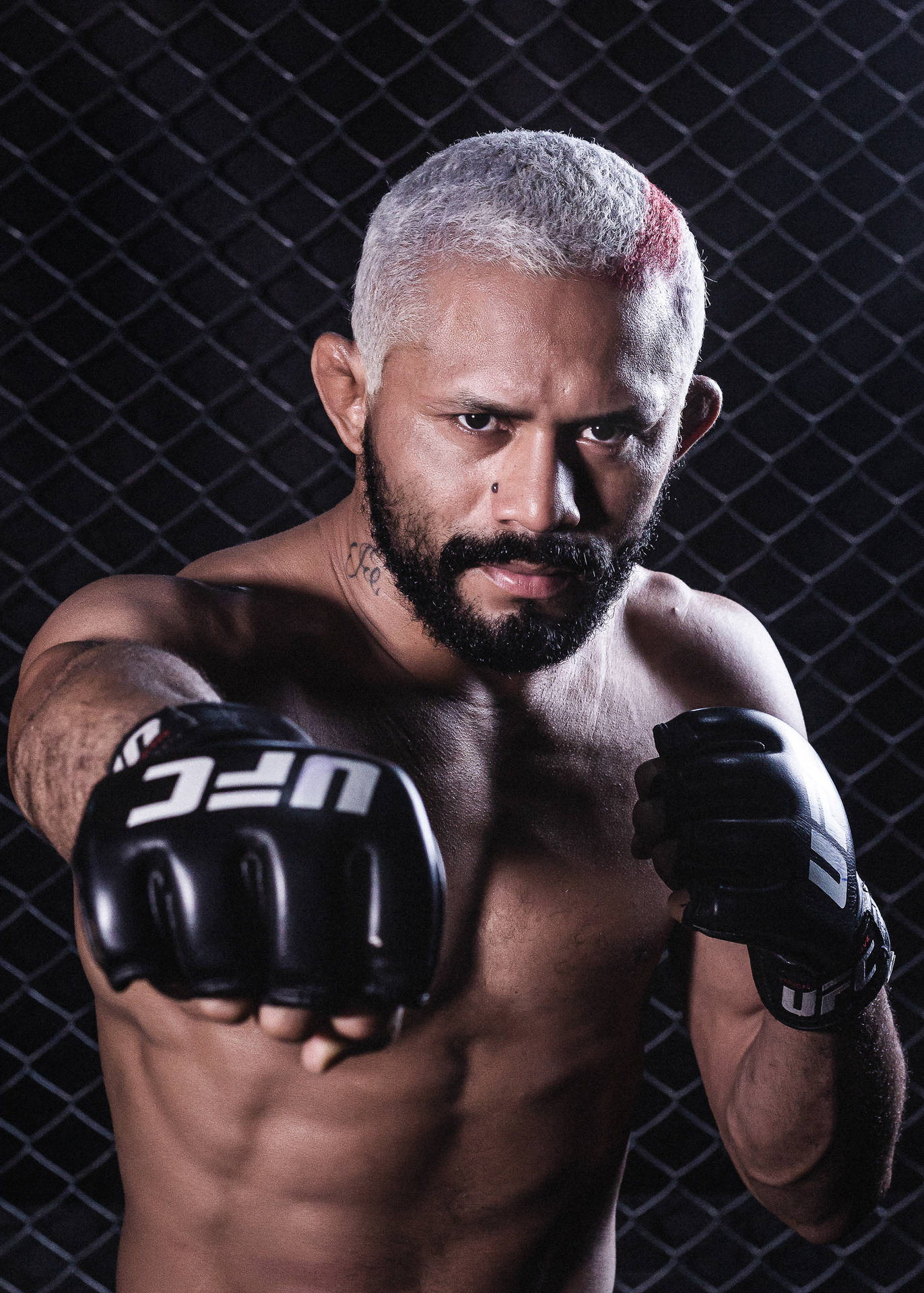 Deiveson Figueiredo Posing With Ufc Gloves Background