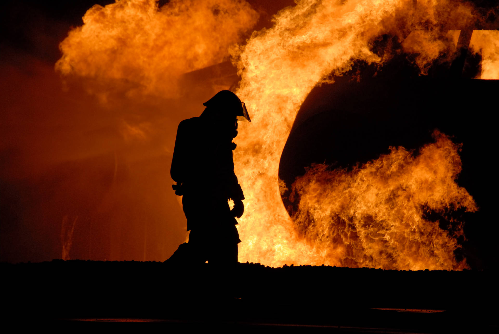 Dejected Fireman In The Middle Of A Fire Background