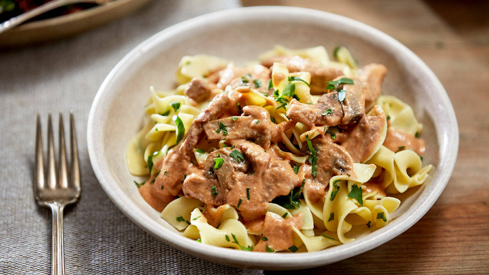 Delectable Beef Stroganoff Served On Pasta Background