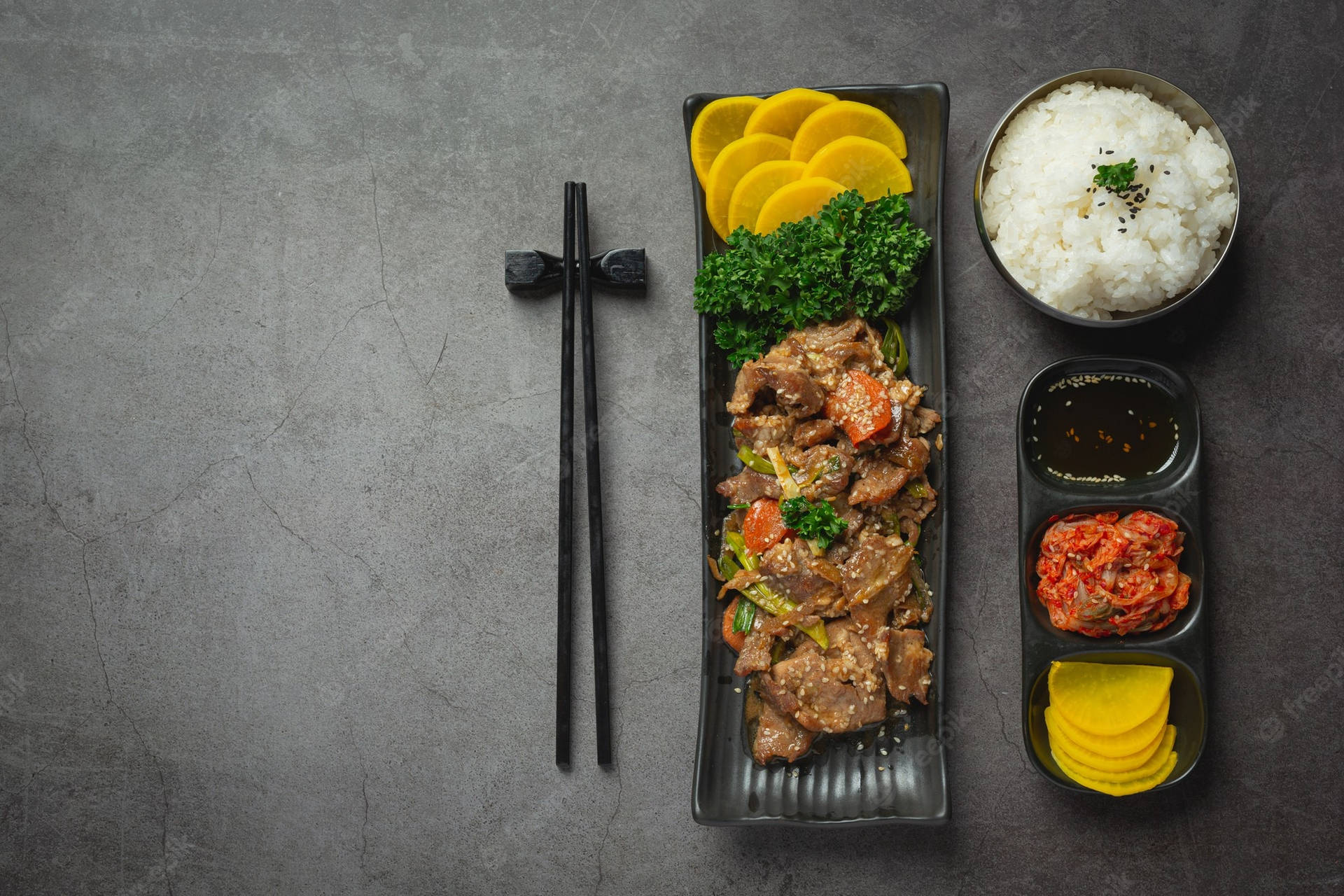 Delectable Bulgogi Dish With Sides And Chopsticks Background