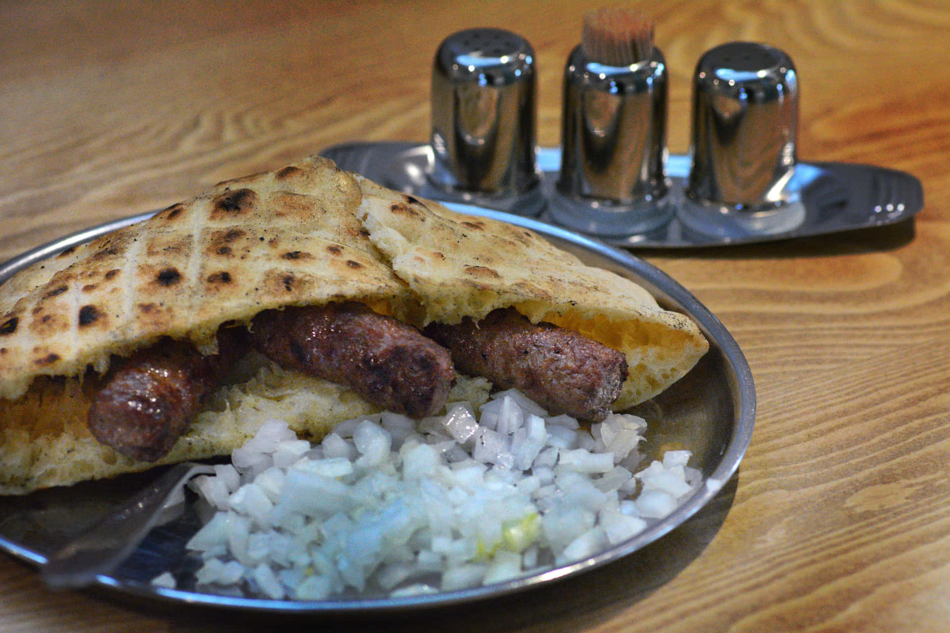 Delectable Ćevapi Tucked Inside Pita Bread Background