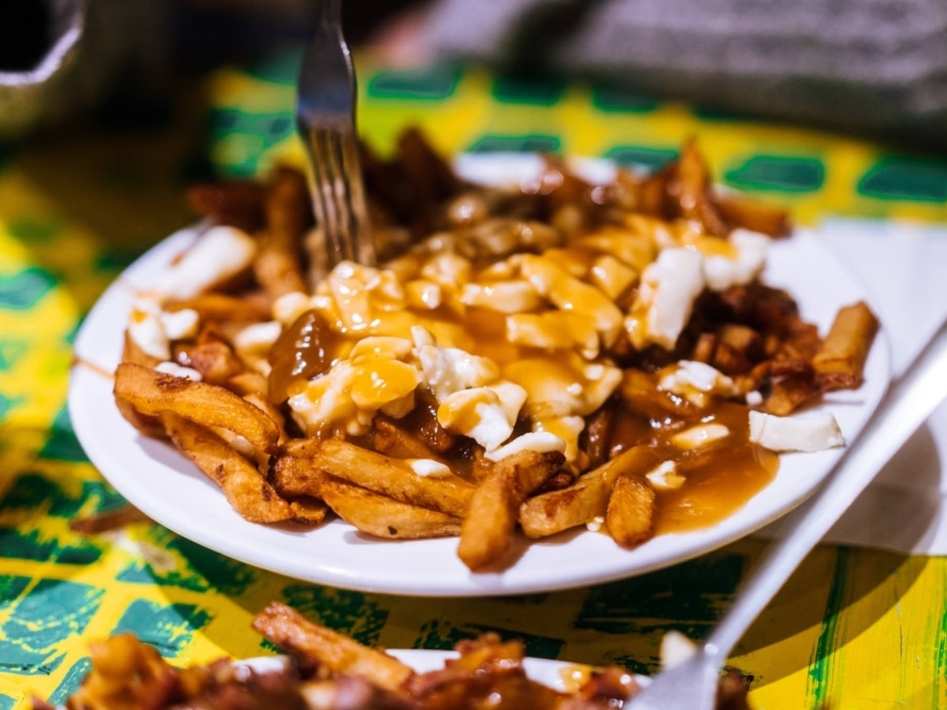 Delectable Forkful Of Poutine Background