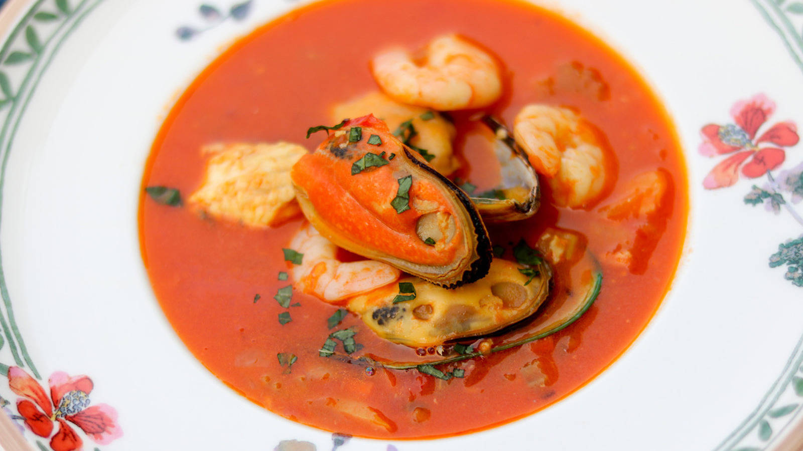 Delectable French Bouillabaisse Served In Floral Plate Background